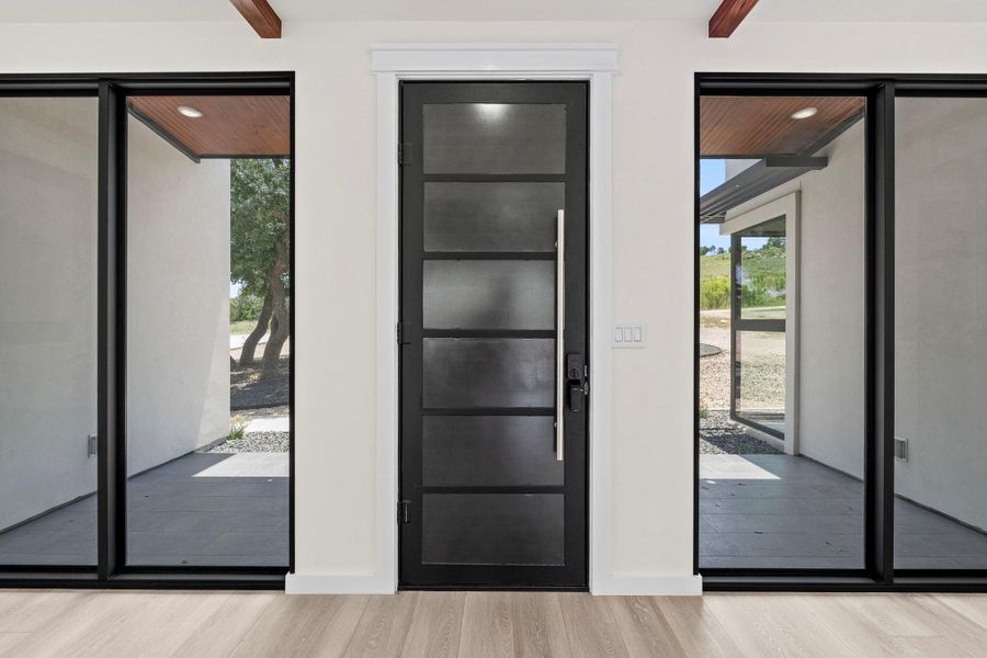 Foyer featuring light wood-style floors and baseboards