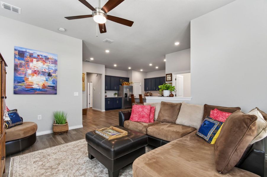 A vibrant living space flows seamlessly into a well-appointed kitchen, ideal for entertaining. A vibrant living space flows seamlessly into a well-appointed kitchen, ideal for entertaining.