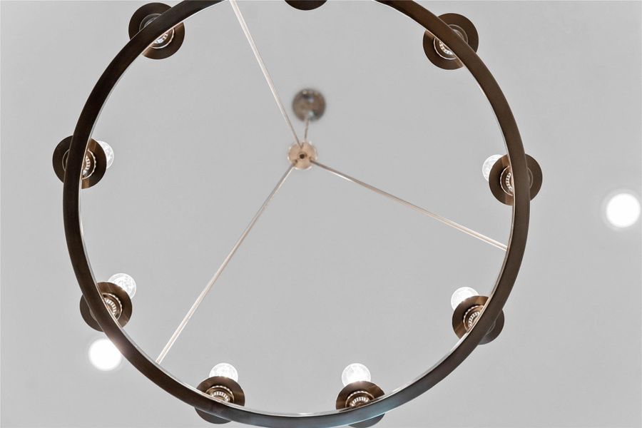 Make a grand first impression with this stunning wagon wheel chandelier gracing the foyer. Finished in elegant brushed nickel, its minimalist open framework and exposed Edison-style bulbs offer a perfect blend of modern industrial and farmhouse charm, casting a warm, inviting glow throughout the entryway.