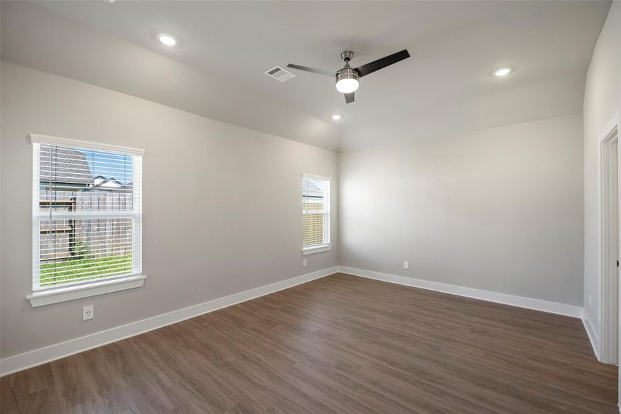 Serene main-level owner’s retreat with LVP and plenty of natural light.