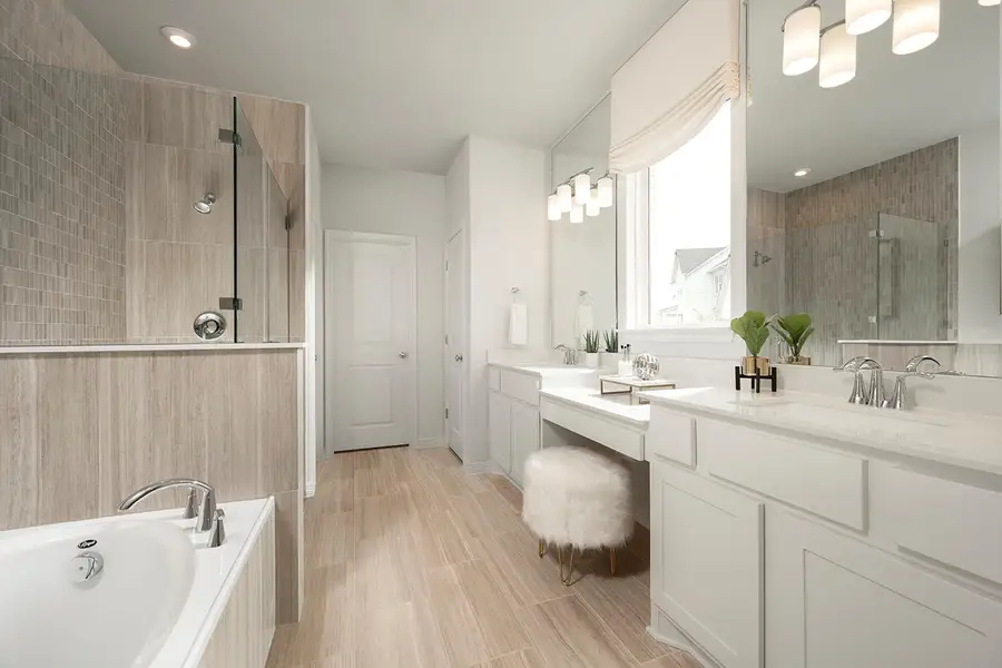 Primary Bath with dual vanities, garden tub & walk-in shower - Representative Photo