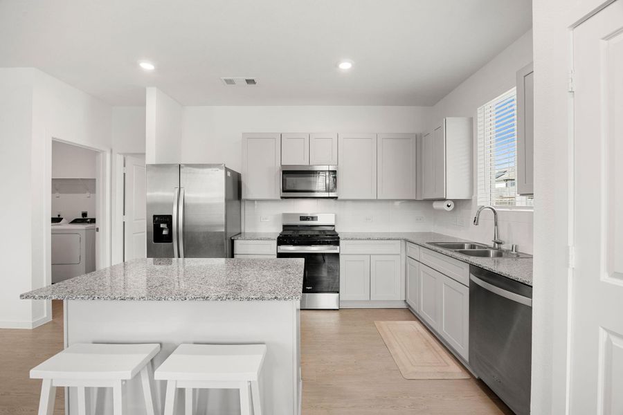 Designed with both style and function in mind, the kitchen showcases sleek finishes, generous counter space, and views into the main living area so you never miss a moment.