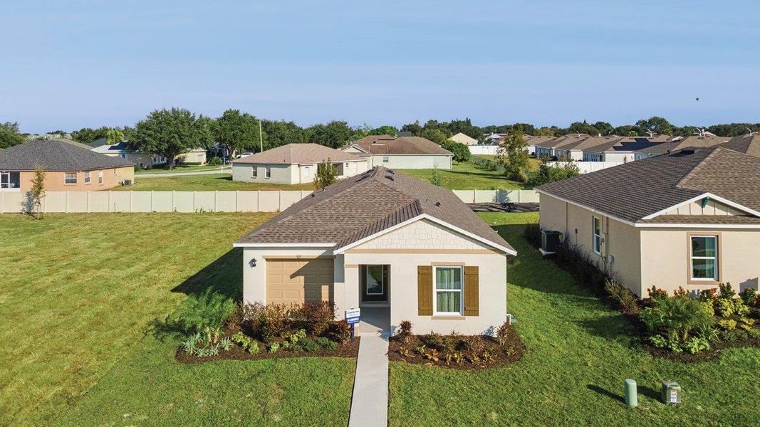 Front exterior of a new home in Leoma's Landing, Lake Wales, FL, highlighting curb appeal (Image 1). Front exterior of a new home in Leoma's Landing, Lake Wales, FL, highlighting curb appeal (Image 1).