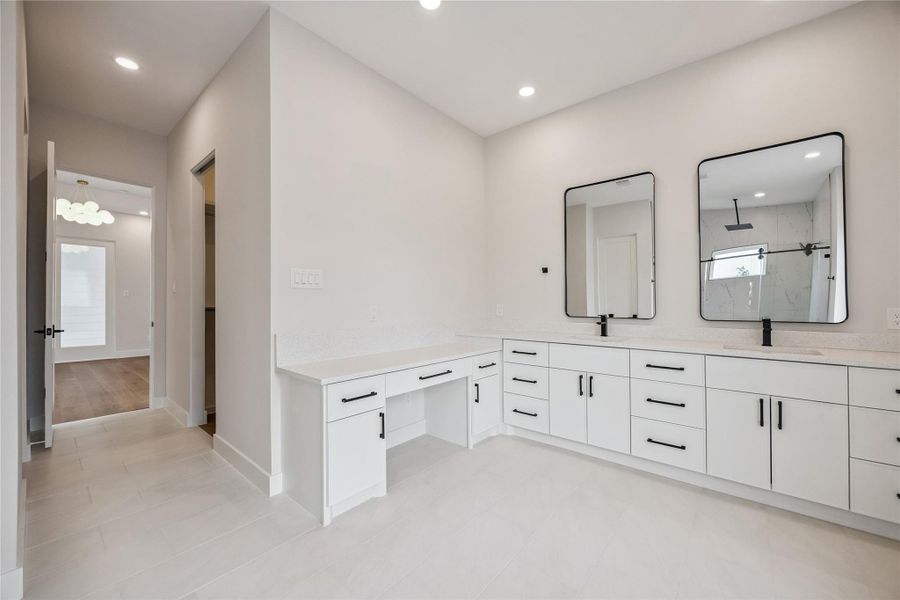 Dual vanities, modern fixtures and give the primary bath a bright and functional layout. The oversized mirror and layered lighting help the space feel open and polished throughout. Dual vanities, modern fixtures and give the primary bath a bright and functional layout. The oversized mirror and layered lighting help the space feel open and polished throughout.