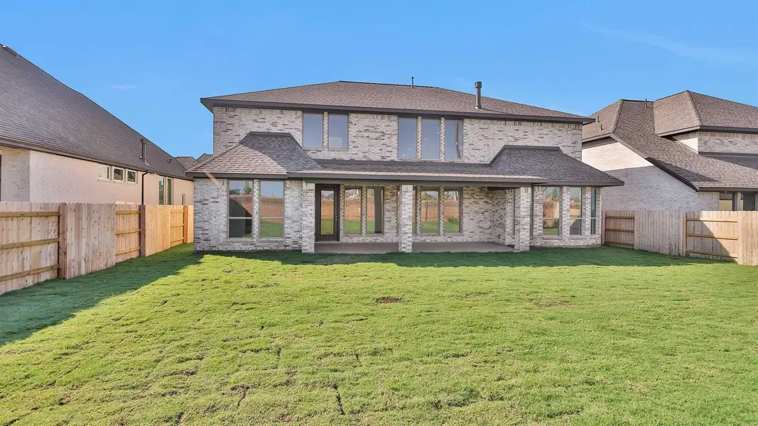 Front exterior of a new home in Elyson 65', Katy, TX, highlighting curb appeal (Image 8). Front exterior of a new home in Elyson 65', Katy, TX, highlighting curb appeal (Image 8).
