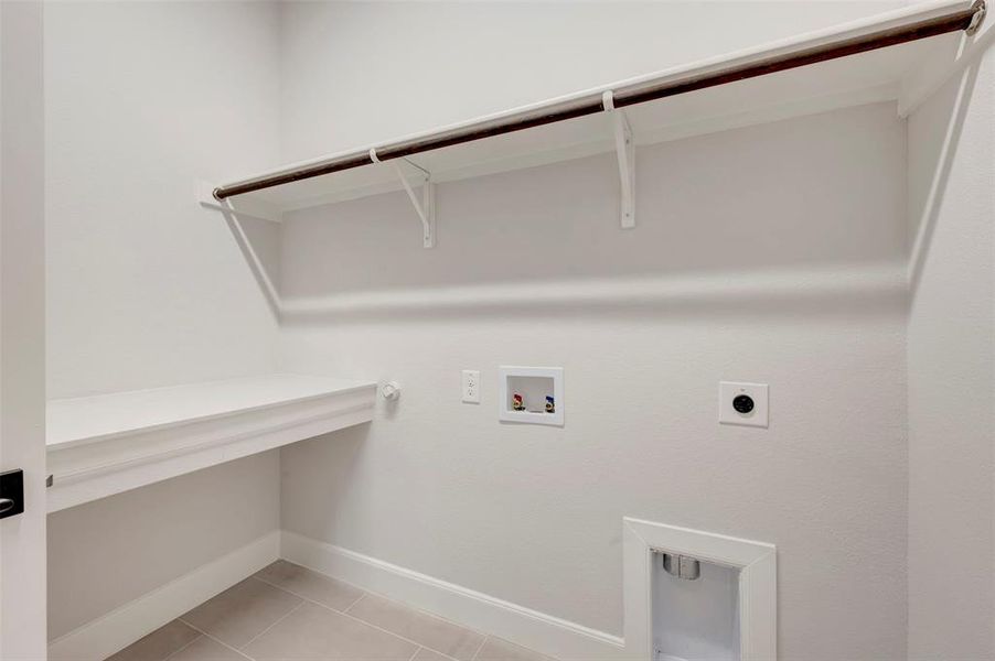 Laundry area featuring gas dryer hookup, light tile patterned flooring, washer hookup, and hookup for an electric dryer