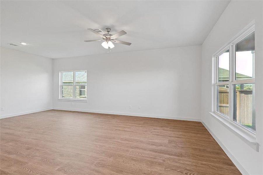 Spare room with ceiling fan and light hardwood / wood-style floors