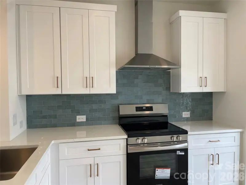 Beautiful kitchen finishes. Crisp white cabinets with a blue backsplash Beautiful kitchen finishes. Crisp white cabinets with a blue backsplash