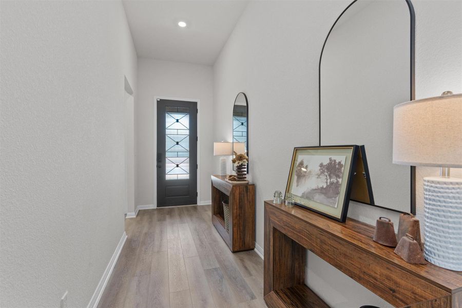 Entryway featuring baseboards and wood finished floors
