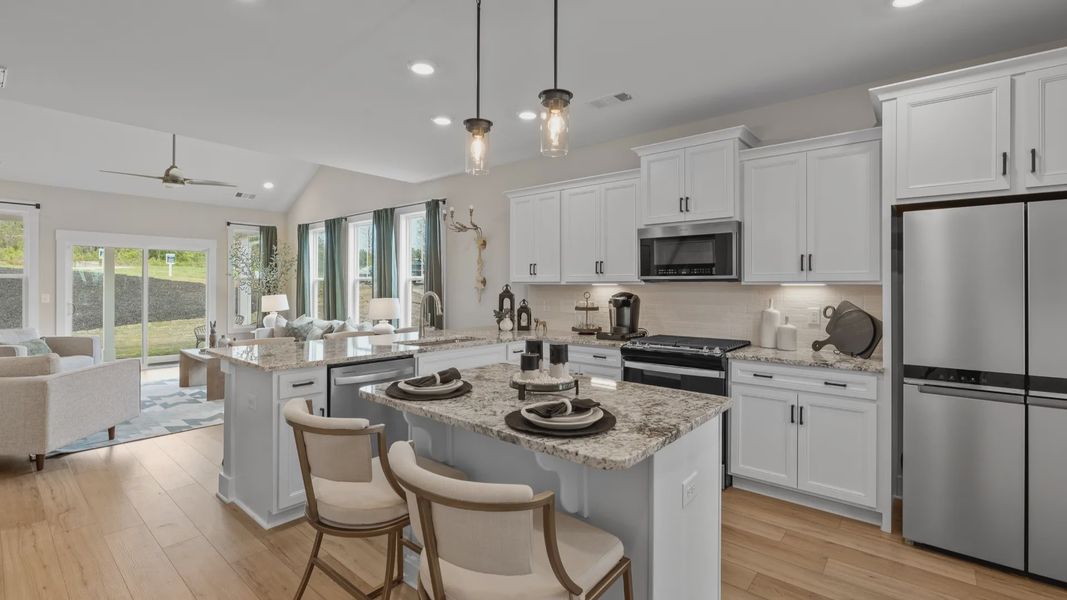 Highly functional kitchen offering a refined look and practical island at the center at the new Barton Hollow community