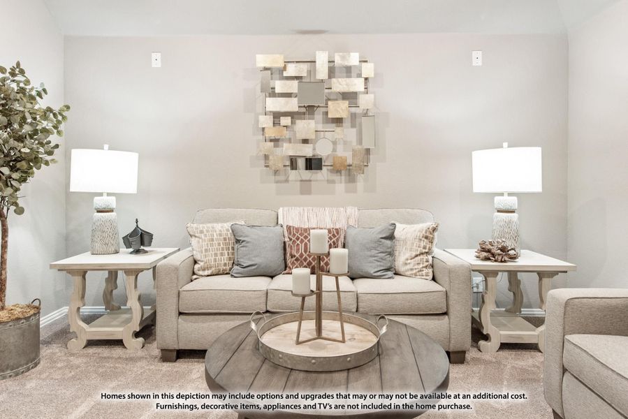 Living room with beige sofa, round wood coffee table, two table lamps, and decorative wall art above the couch Living room with beige sofa, round wood coffee table, two table lamps, and decorative wall art above the couch