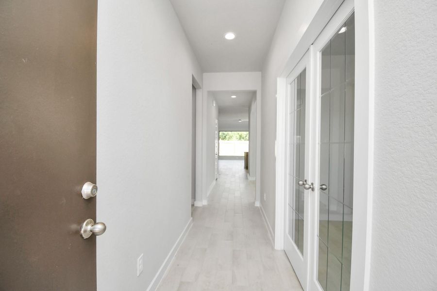 As you step into the threshold of this luxurious home, you'll soon be welcomed by an elegant glass door (to be installed). Inside, soaring ceilings amplify the spaciousness, while the refined wood-look tile flooring and oversized baseboards exude sophistication and charm. Sample photo of completed home with similar floor plan. Actual colors and selections may vary.