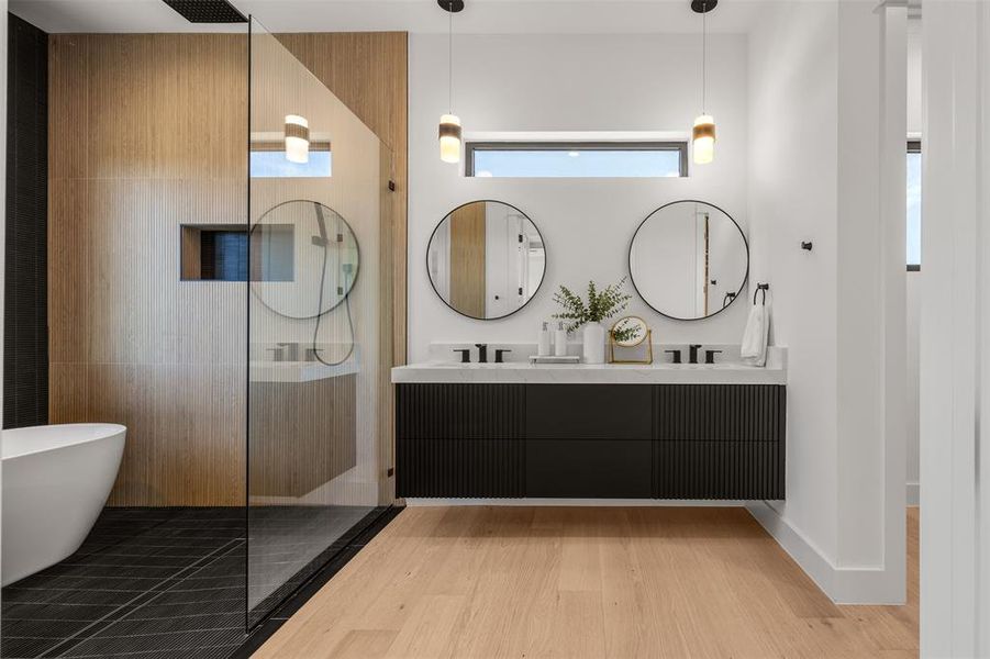 Luxurious bathing space showcasing a dual vanity and a spacious glass-enclosed shower with a modern tub.