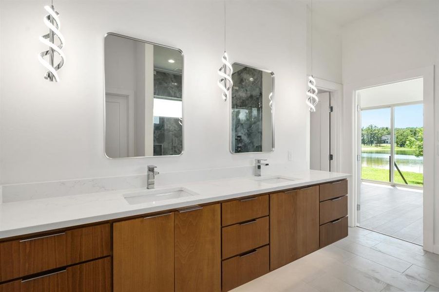 1st floor primary bathroom with water views, large shower - tub combo and dual sinks.