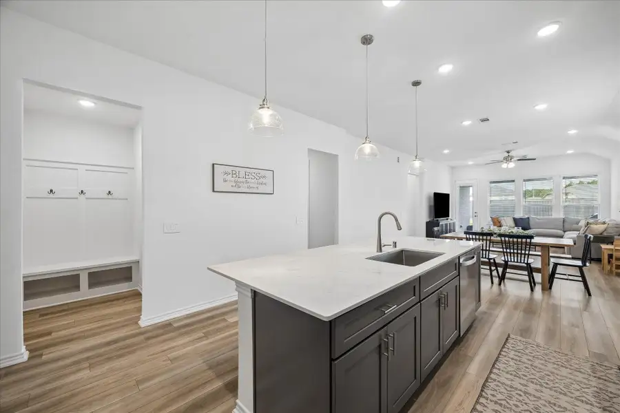 Spacious breakfast bar with seating for casual dining, morning coffee, or gathering with family and friends while staying connected to the kitchen and living areas.