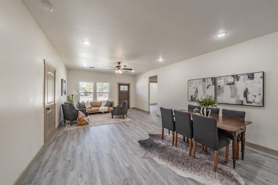 Dining space featuring light wood-style flooring, ceiling fan, and recessed lighting