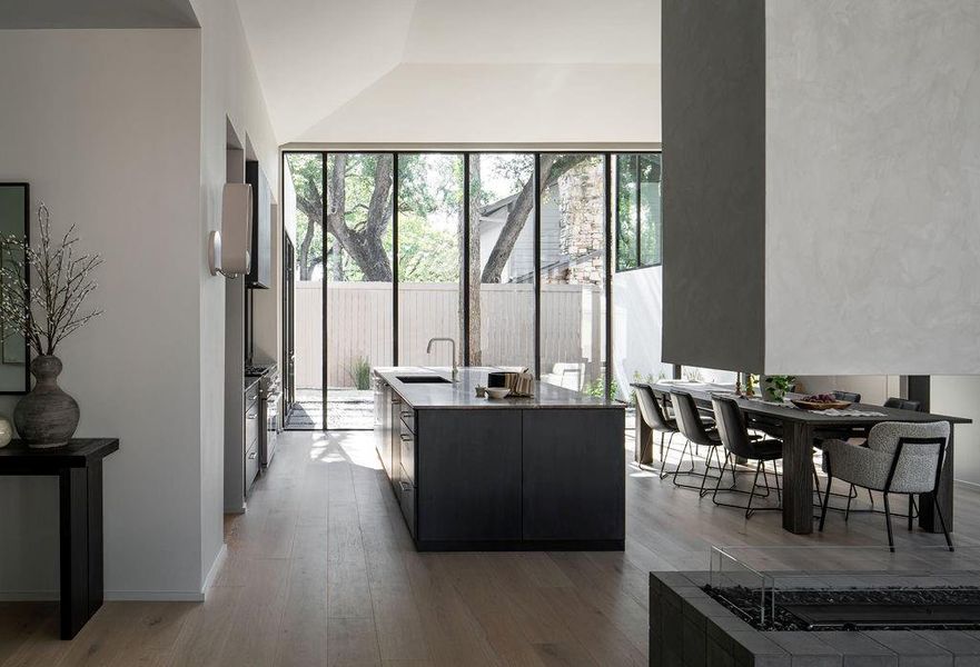 Another view of the incredible natural light and peaceful courtyard gracing the kitchen and dining area.