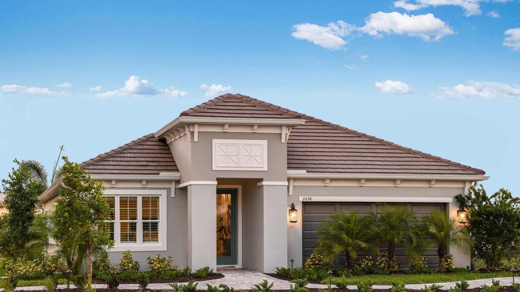 Front exterior of a new home in Windward, Lakewood Ranch, FL, highlighting curb appeal (Image 2). Front exterior of a new home in Windward, Lakewood Ranch, FL, highlighting curb appeal (Image 2).