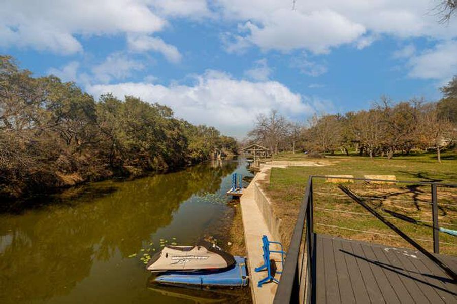 Dock with a water view and view of scattered trees