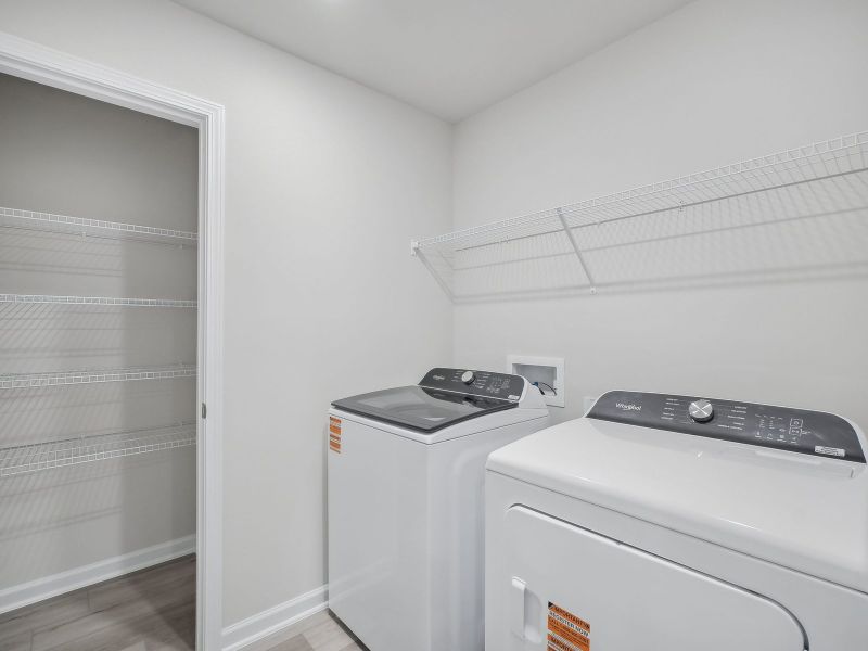 The upstairs laundry room offers extra storage space to simplify the chore.