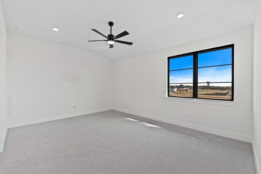 Media room with light colored carpet, lofted ceiling, ceiling fan, and recessed lighting