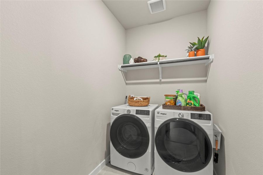Functional laundry room equipped with modern appliances and convenient shelving for storage. Functional laundry room equipped with modern appliances and convenient shelving for storage.