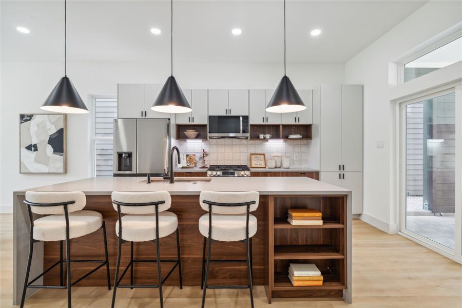 This statement island isn’t just a showpiece—it features built-in shelving for added function and generous seating space for effortless gatherings and everyday convenience. This statement island isn’t just a showpiece—it features built-in shelving for added function and generous seating space for effortless gatherings and everyday convenience.