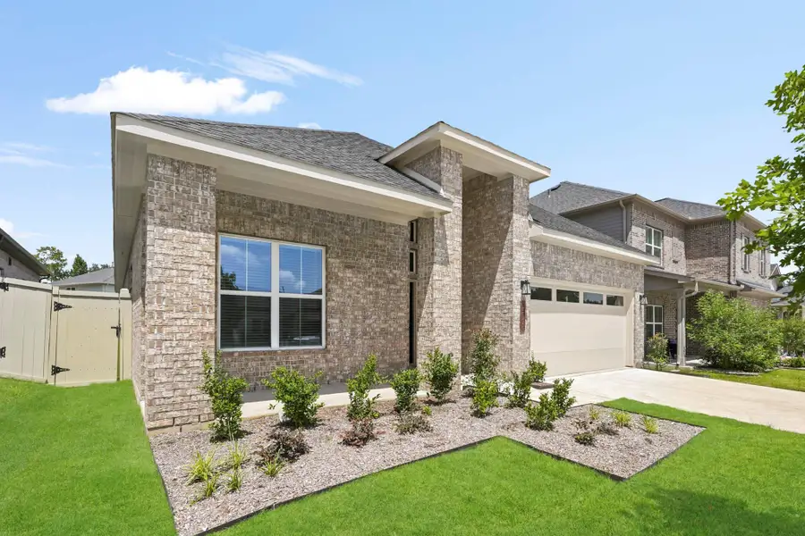 Front exterior of a new home in Audubon, Magnolia, TX, highlighting curb appeal (Image 2). Front exterior of a new home in Audubon, Magnolia, TX, highlighting curb appeal (Image 2).