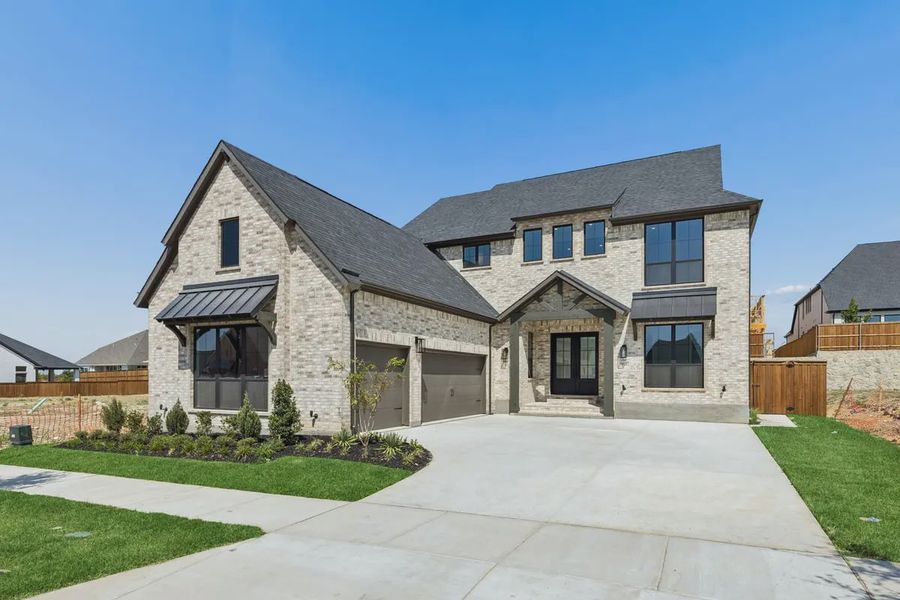 Front exterior of a new home in The Grove Frisco, Frisco, TX, highlighting curb appeal (Image 2). Front exterior of a new home in The Grove Frisco, Frisco, TX, highlighting curb appeal (Image 2).