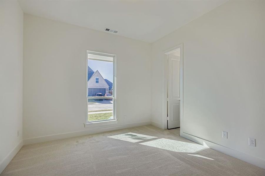 Unfurnished room featuring light colored carpet and baseboards Unfurnished room featuring light colored carpet and baseboards