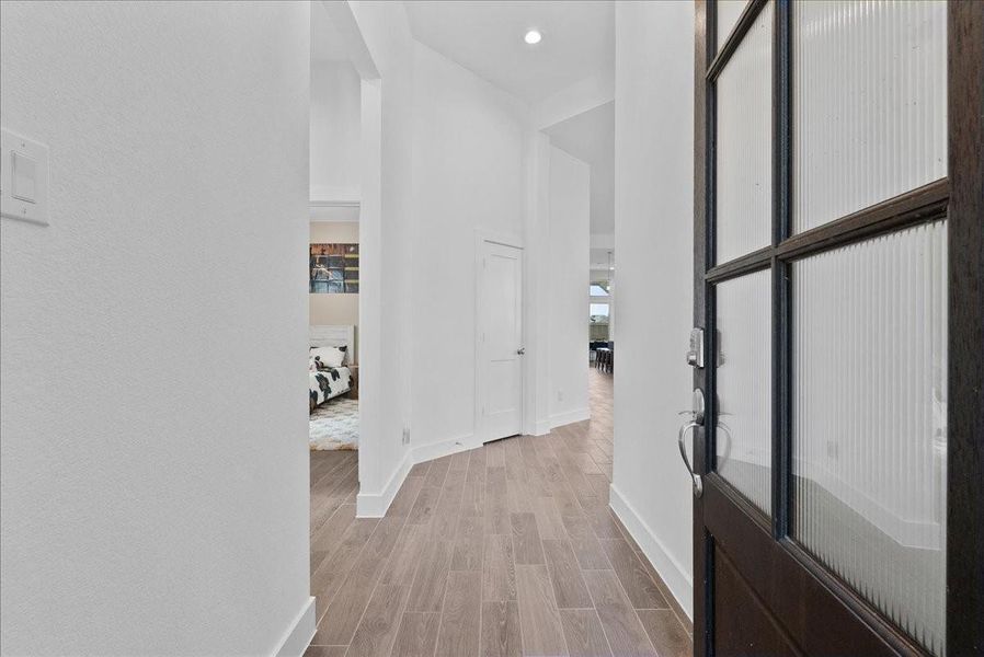 A spacious entry creates a warm welcome, with two front bedrooms conveniently located off the entry and a private hallway guiding you toward the family room. A spacious entry creates a warm welcome, with two front bedrooms conveniently located off the entry and a private hallway guiding you toward the family room.