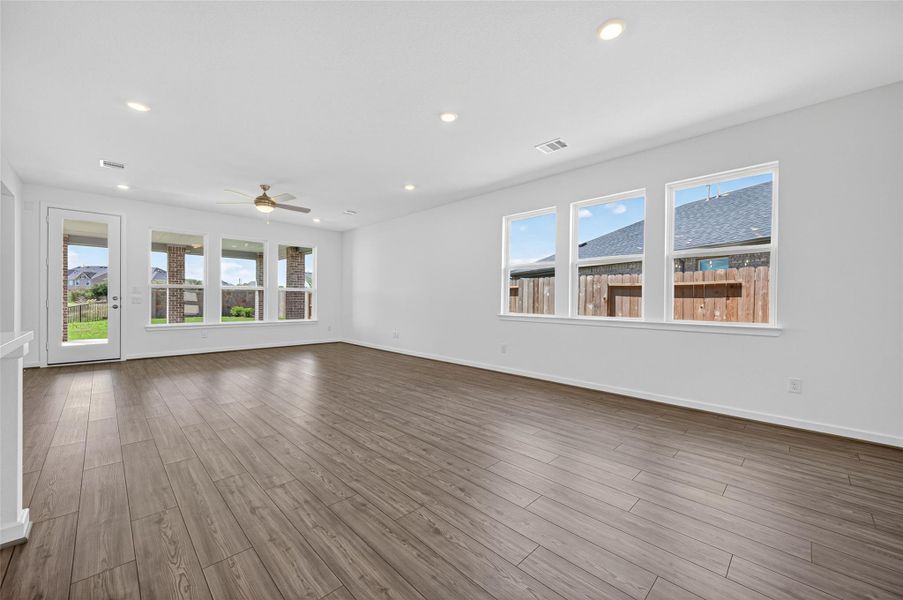 This spacious open-concept living area offers abundant natural light and flows seamlessly into the kitchen, creating the perfect setting for both relaxing and entertaining.