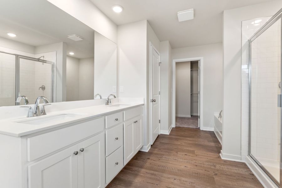 A bathroom with white cabinets.