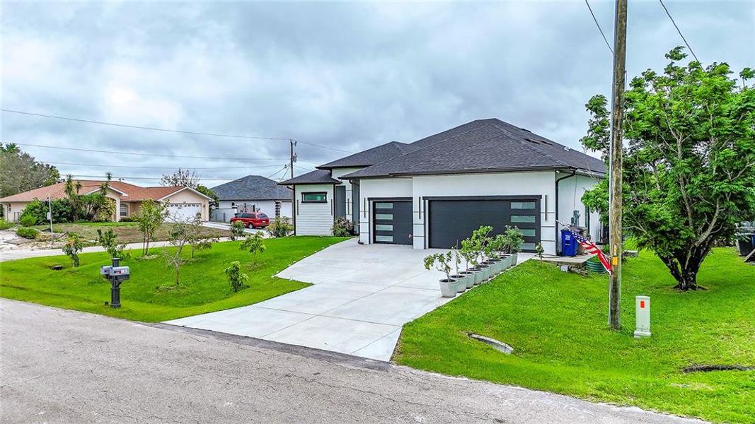 Front exterior of a new home in , Lehigh Acres, FL, highlighting curb appeal (Image 24).