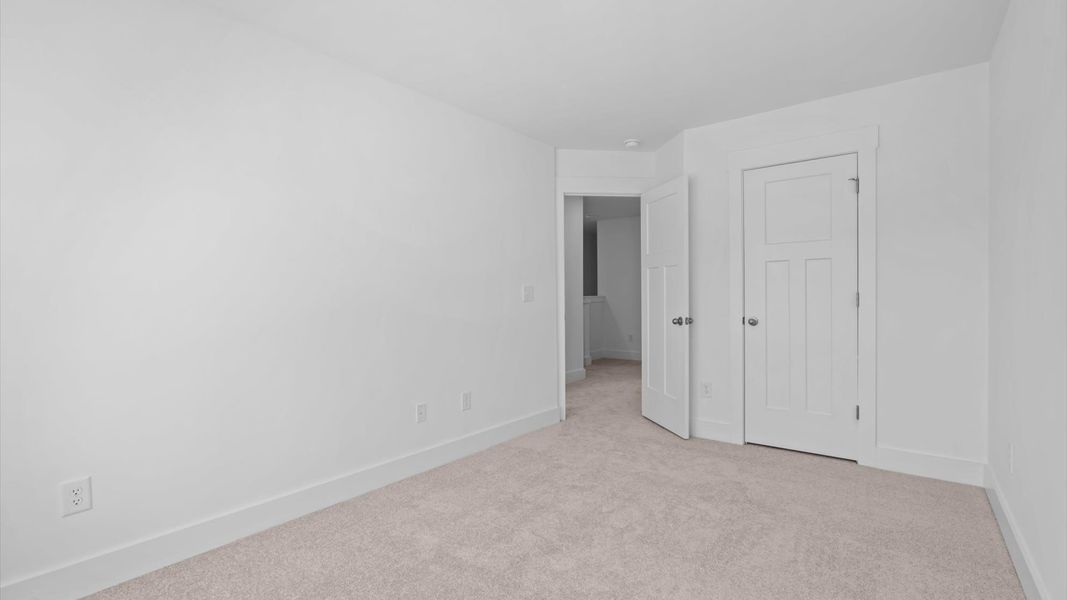 Elegant carpeted bedroom with walk-in closet and wall-to-wall windows offering natural brightness at Silo Ridge