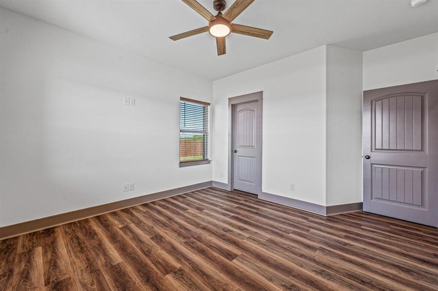 Unfurnished bedroom with dark wood-type flooring, ceiling fan, and a closet