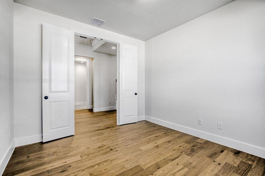 Unfurnished bedroom featuring light wood-style floors and baseboards