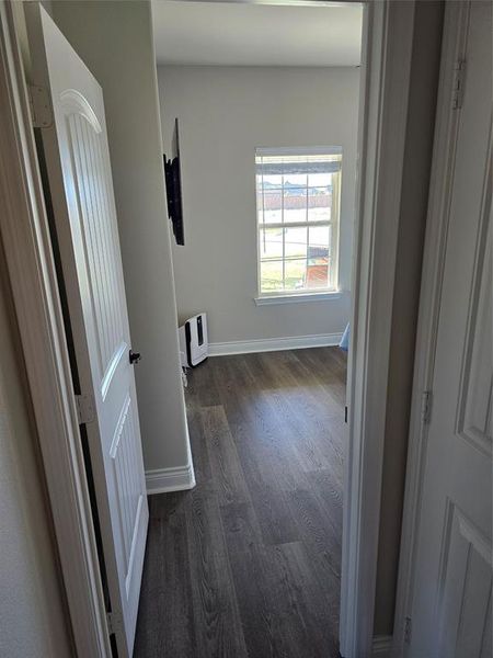 Corridor featuring dark hardwood / wood-style flooring