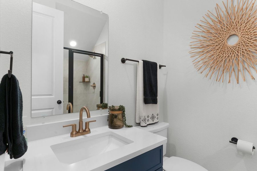 Full bathroom with vanity, toilet, and a tile shower