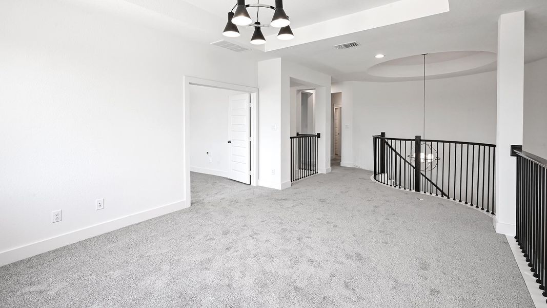 Unfurnished room featuring a chandelier, carpet, baseboards, and a tray ceiling Unfurnished room featuring a chandelier, carpet, baseboards, and a tray ceiling