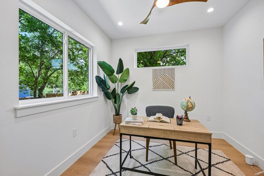 A quiet office space features expansive windows and durable hardwood flooring prewired for GFiber access. If no home office is needed, this room could be a formal dining. A quiet office space features expansive windows and durable hardwood flooring prewired for GFiber access. If no home office is needed, this room could be a formal dining.