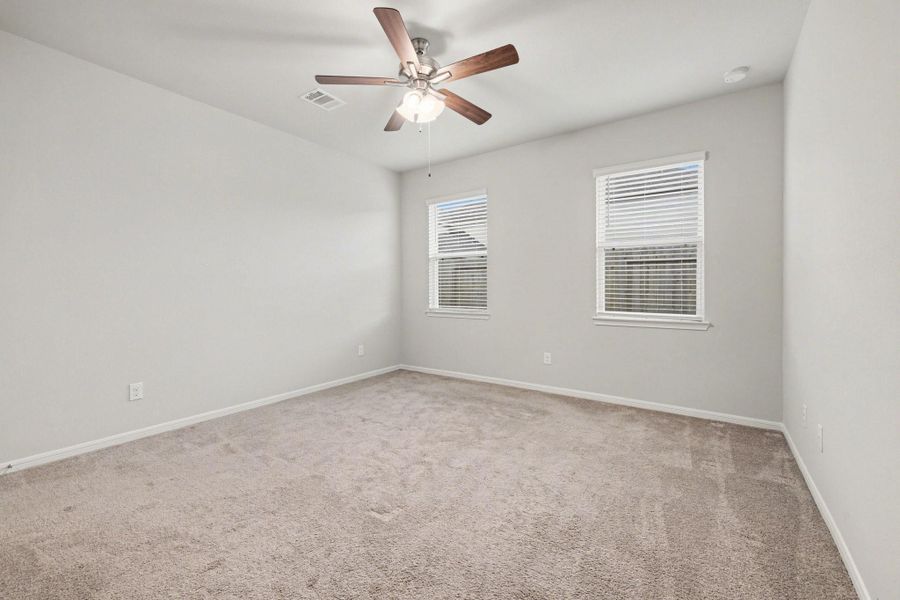 Alternate view of primary bedroom showing spacious layout and neutral finishes. Alternate view of primary bedroom showing spacious layout and neutral finishes.