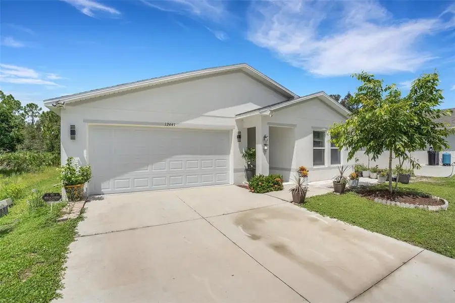 Front exterior of a new home in , Punta Gorda, FL, highlighting curb appeal (Image 2). Front exterior of a new home in , Punta Gorda, FL, highlighting curb appeal (Image 2).