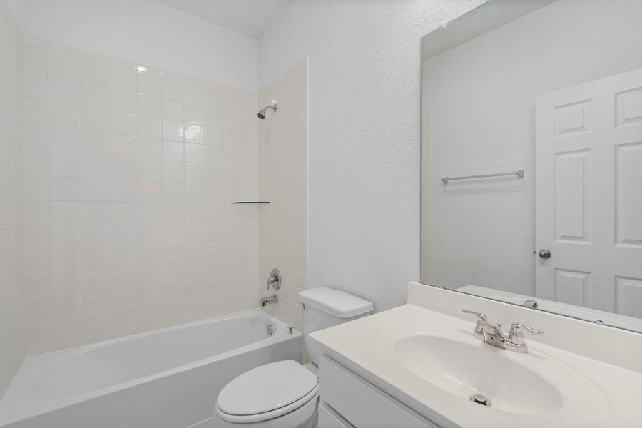 The secondary bath features tile flooring, white cabinetry and light countertops and a shower/tub combo. Perfect for accommodating any visiting family and friends. The secondary bath features tile flooring, white cabinetry and light countertops and a shower/tub combo. Perfect for accommodating any visiting family and friends.