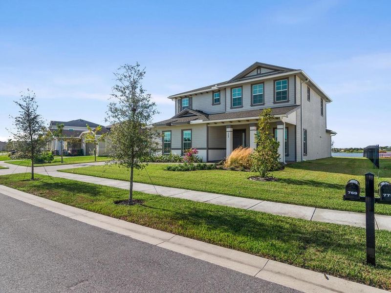 Front exterior of a new home in , The Acreage, FL, highlighting curb appeal (Image 22). Front exterior of a new home in , The Acreage, FL, highlighting curb appeal (Image 22).