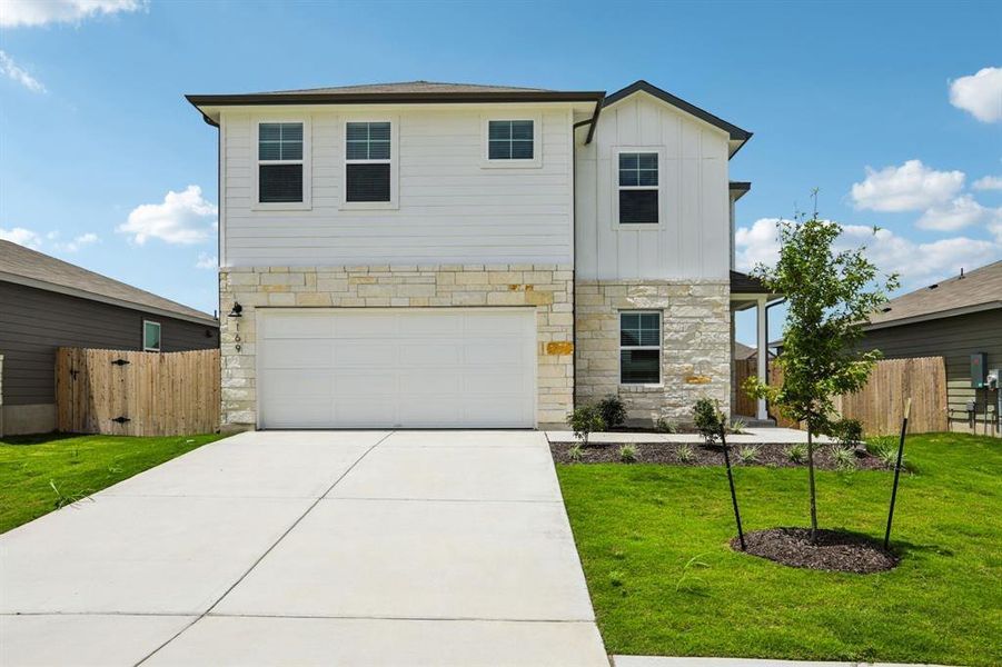 View of front of house with stone siding, board and batten siding, a garage, and concrete driveway View of front of house with stone siding, board and batten siding, a garage, and concrete driveway