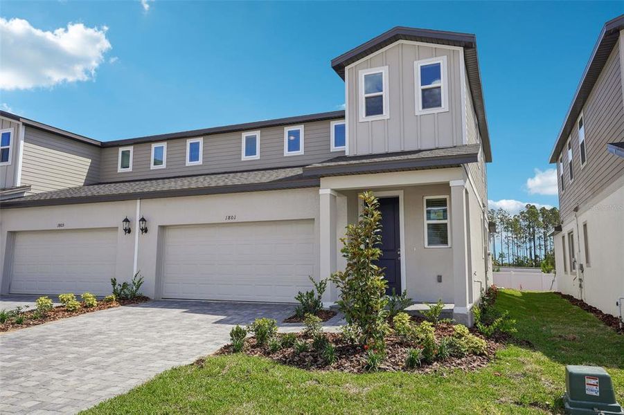 Front exterior of a new home in Cyrene at Minneola - Villas, Montverde, FL, highlighting curb appeal (Image 21). Front exterior of a new home in Cyrene at Minneola - Villas, Montverde, FL, highlighting curb appeal (Image 21).