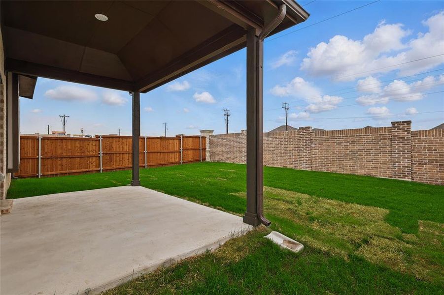 Fenced backyard featuring a patio