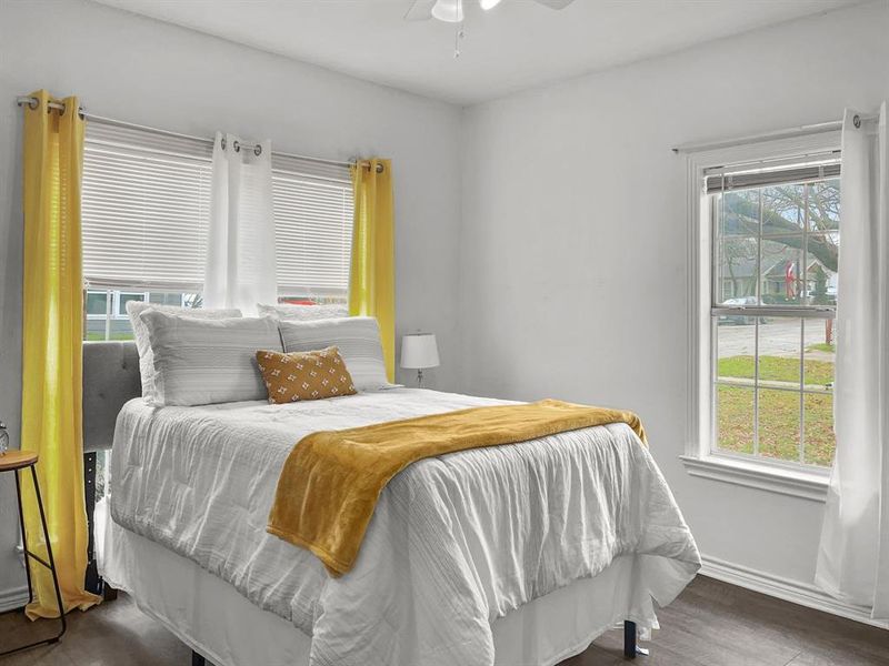 Primary Bedroom featuring dark wood-style floors, lots of natura light, and ceiling fan