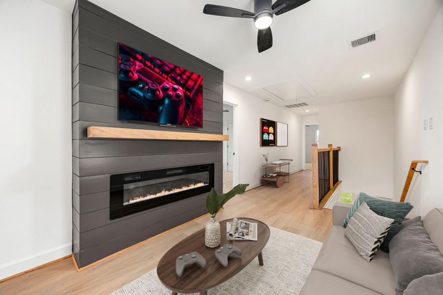 An upstairs living area offers a cozy retreat with a striking modern fireplace feature, clean lines, and an open layout that provides flexibility for a media room, lounge, or additional entertaining space.